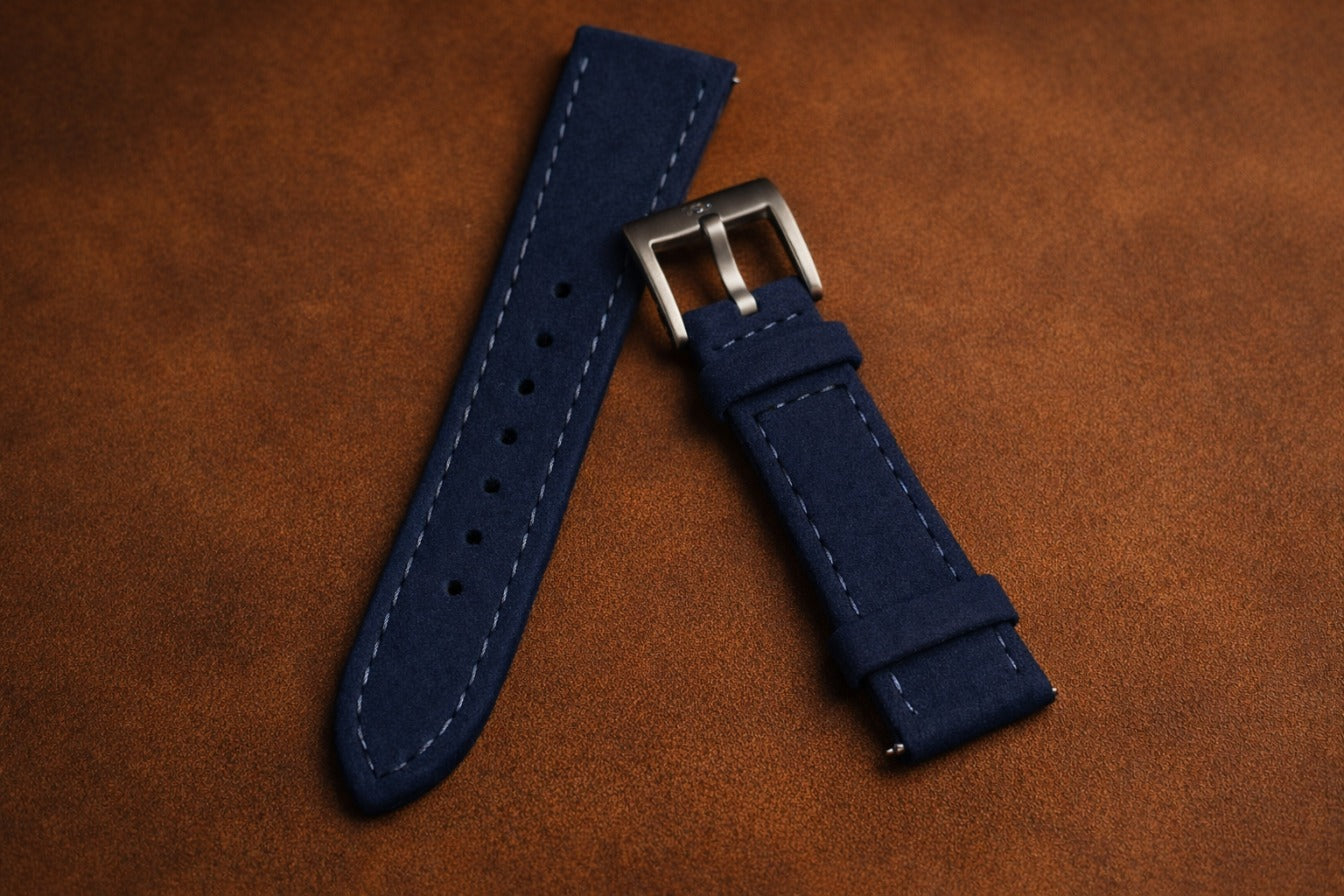 Top grain navy leather watch strap with reinforced stitching and brushed steel buckle, classic replacement band for dress and everyday watches.